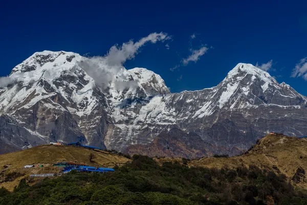 Towering Annapurna peaks viewed from the exposed ridge at Mid Camp