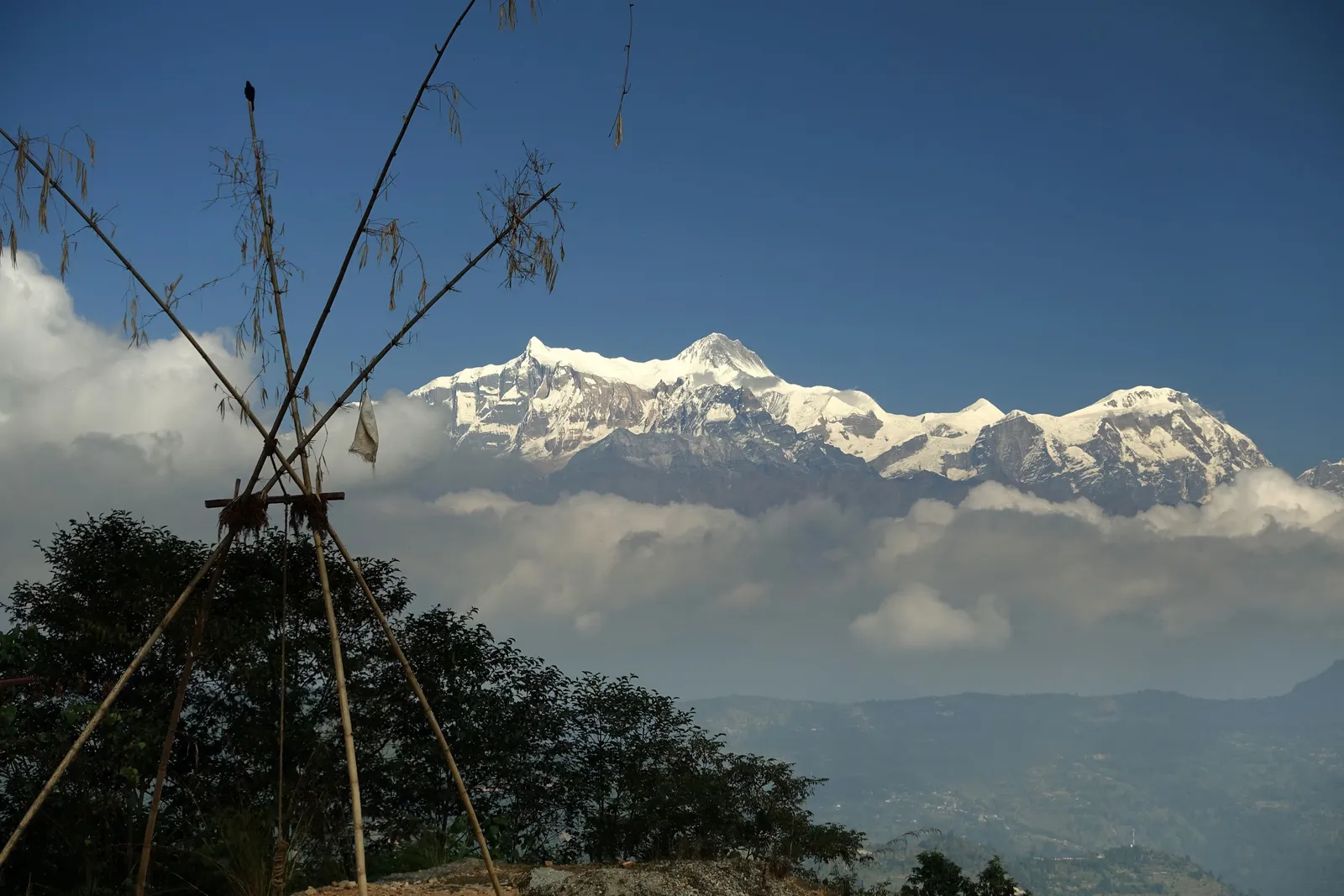 Annapurna South peaks rising above a blanket of morning clouds
