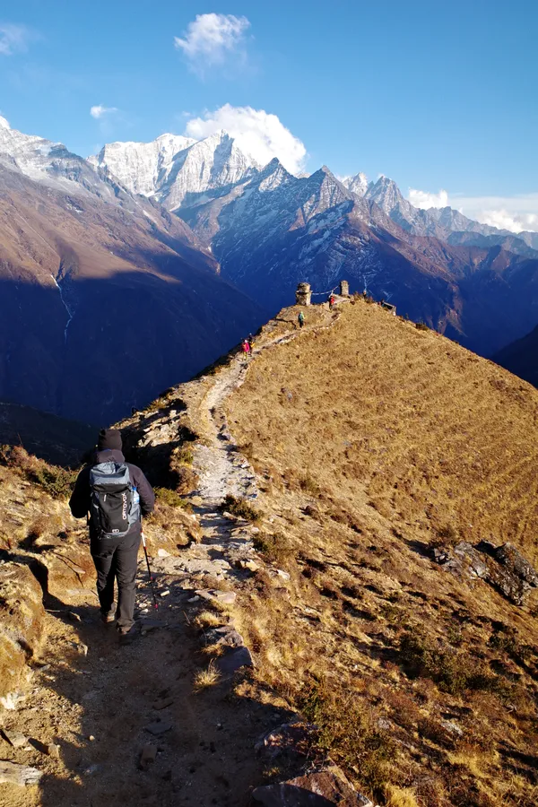 Trekkers climbing toward Nangkartshang Peak for high-altitude acclimatization