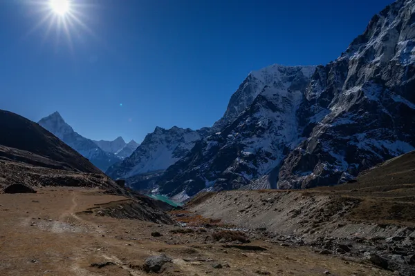 Cholatse Lake glimmering below the rocky trail at 4,900 m