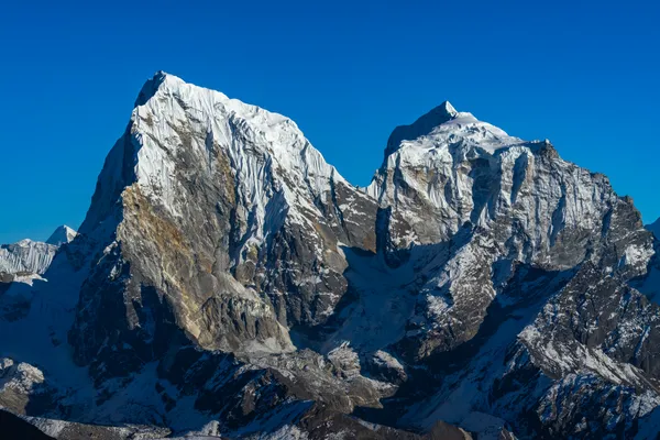 The ice-plastered faces of the Chamar massif dominating the skyline