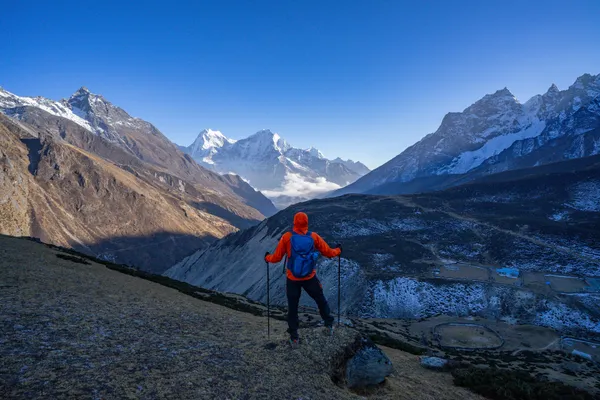 A trekker stands at 5,357 meters surveying the Dudh Koshi Valley