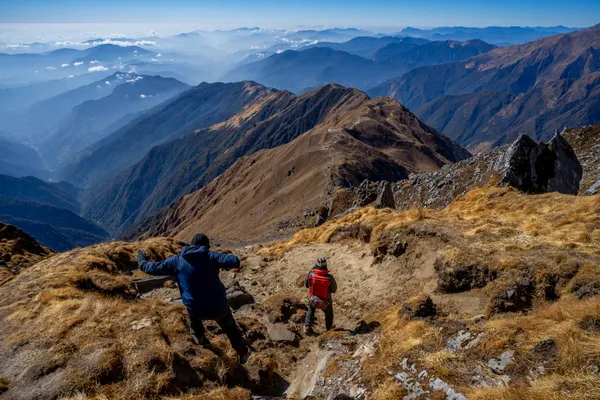 Trekkers navigating the narrow high-altitude path from base camp