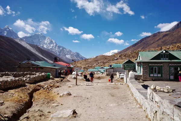 Trekkers entering Dingboche at 4,410 m with Ama Dablam nearby