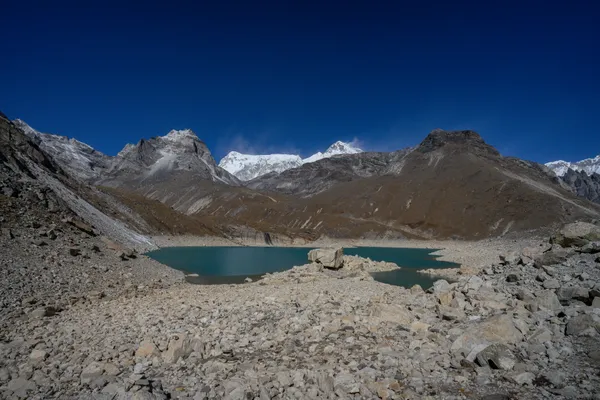 Trekkers observing the pristine waters of the 4,990 m Fifth Lake