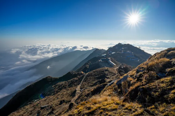 High Camp lodges perched on a narrow ridge above an ocean of clouds