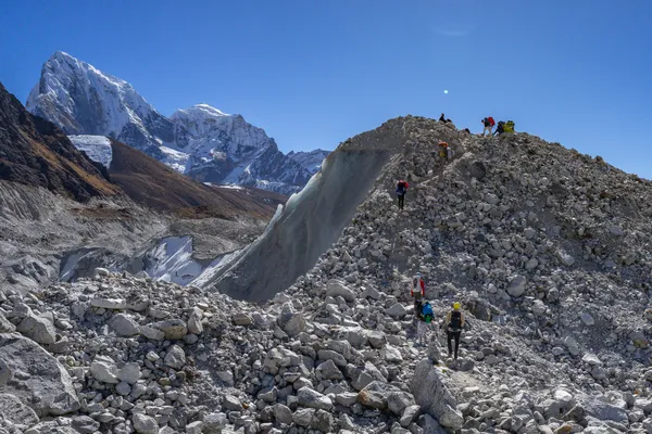 Trekkers navigating the debris-covered Ngozumpa Glacier