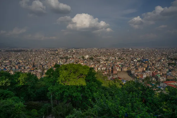 Panoramic view of Kathmandu city and green hillsides from a mountain viewpoint