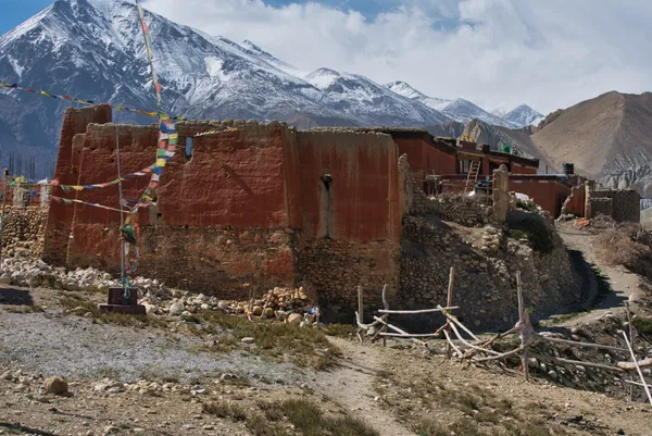 The historic Lo Gekar Monastery at 3,950 m standing against snow-capped peaks on the approach to Lo Manthang