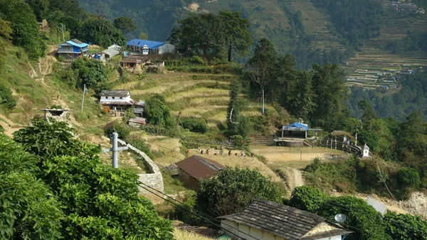Traditional stone houses and terraced farm fields in the hillside settlement of Lwang