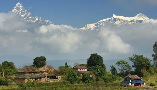 The pyramid of Machhapuchhre dominating the horizon above rolling foothills