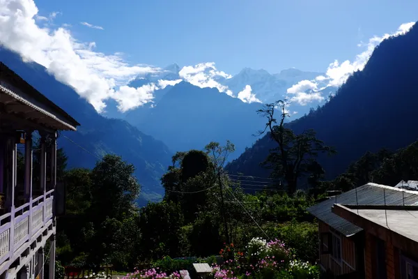 Snow-capped peaks beyond a mountain teahouse