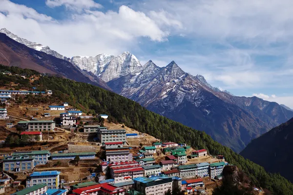 Colorful buildings of Namche Bazaar tucked into a mountain curve