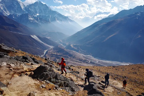 Trekkers climbing the steep, rocky ridge above Dingboche