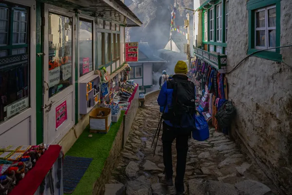 A trekker navigating the stone-paved alleys of Namche Bazaar