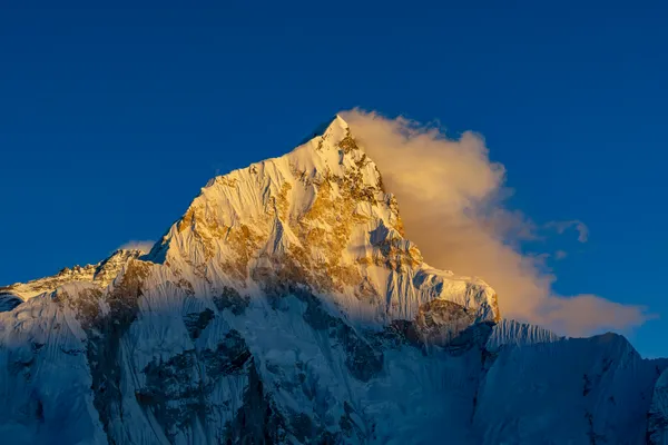 Sunset light striking the 7,861-meter summit of Nuptse