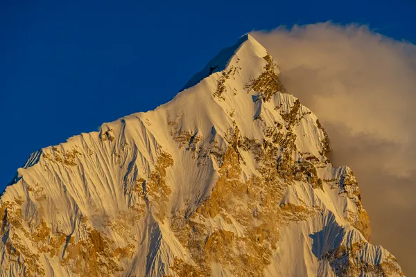 The summit of Nuptse glowing in sunset light