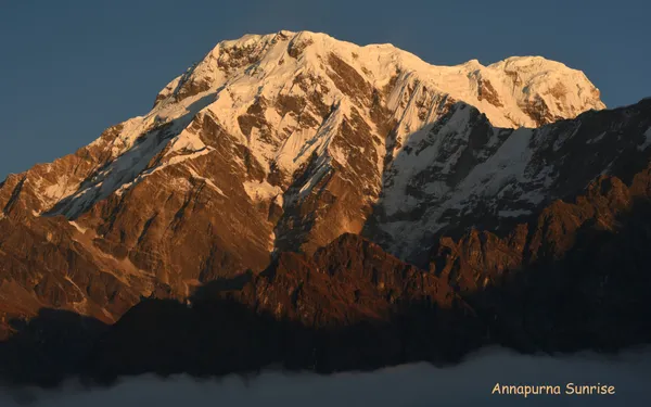 Annapurna South bathed in golden sunrise light