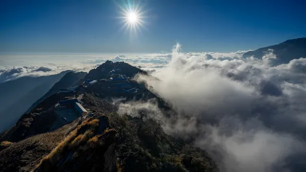 A ridge-top settlement surrounded by a sea of clouds at sunrise