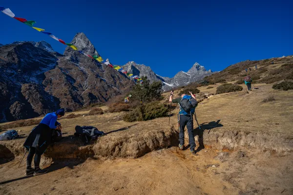 Colorful prayer flags flutter at the junction where the trail splits toward Gokyo