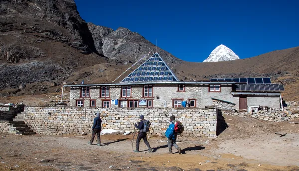 Trekkers passing the iconic Pyramid Laboratory near Lobuche