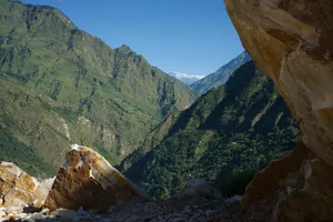 Massive rock faces with distant snow-capped peaks