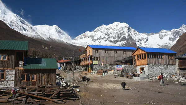 A peaceful stone village perched at the foot of the high Himalayas