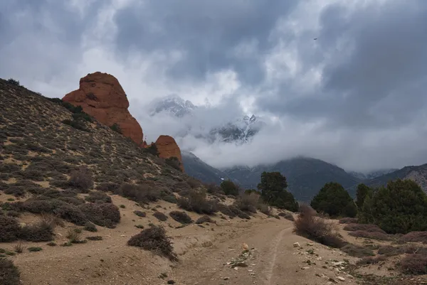 A dusty trekking trail winding through canyon landscape toward the remote village of Dhi