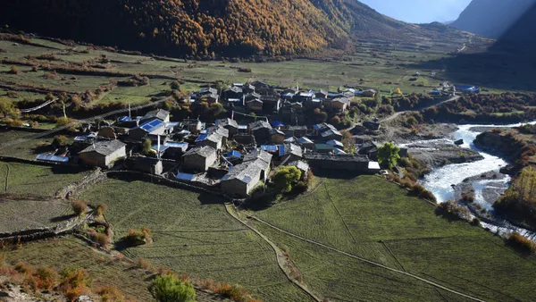 Chhule village with stone houses along the riverbank