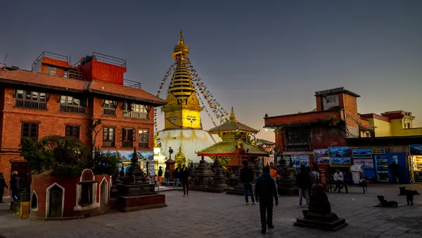 The golden Swayambhunath Stupa illuminated at dusk