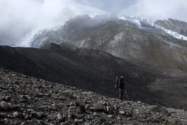 Rocky terrain beneath glaciers near the summit