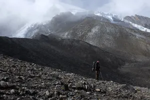 Rocky terrain beneath glaciers near the summit