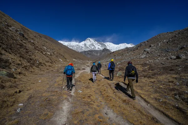 Trekkers traverse the high alpine valley toward Cho Oyu at 4,900 meters