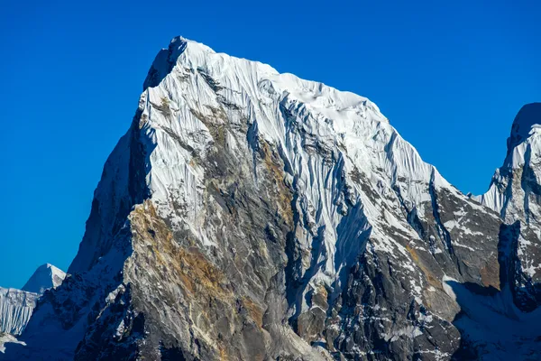 Hikers overlooking the vast Ngozumpa Glacier from a 4,950 m ridge